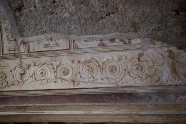 Italy, Pompeii,Forum Baths, view of the Tapidaruim with coloured stucco and shelves separated by telamones7